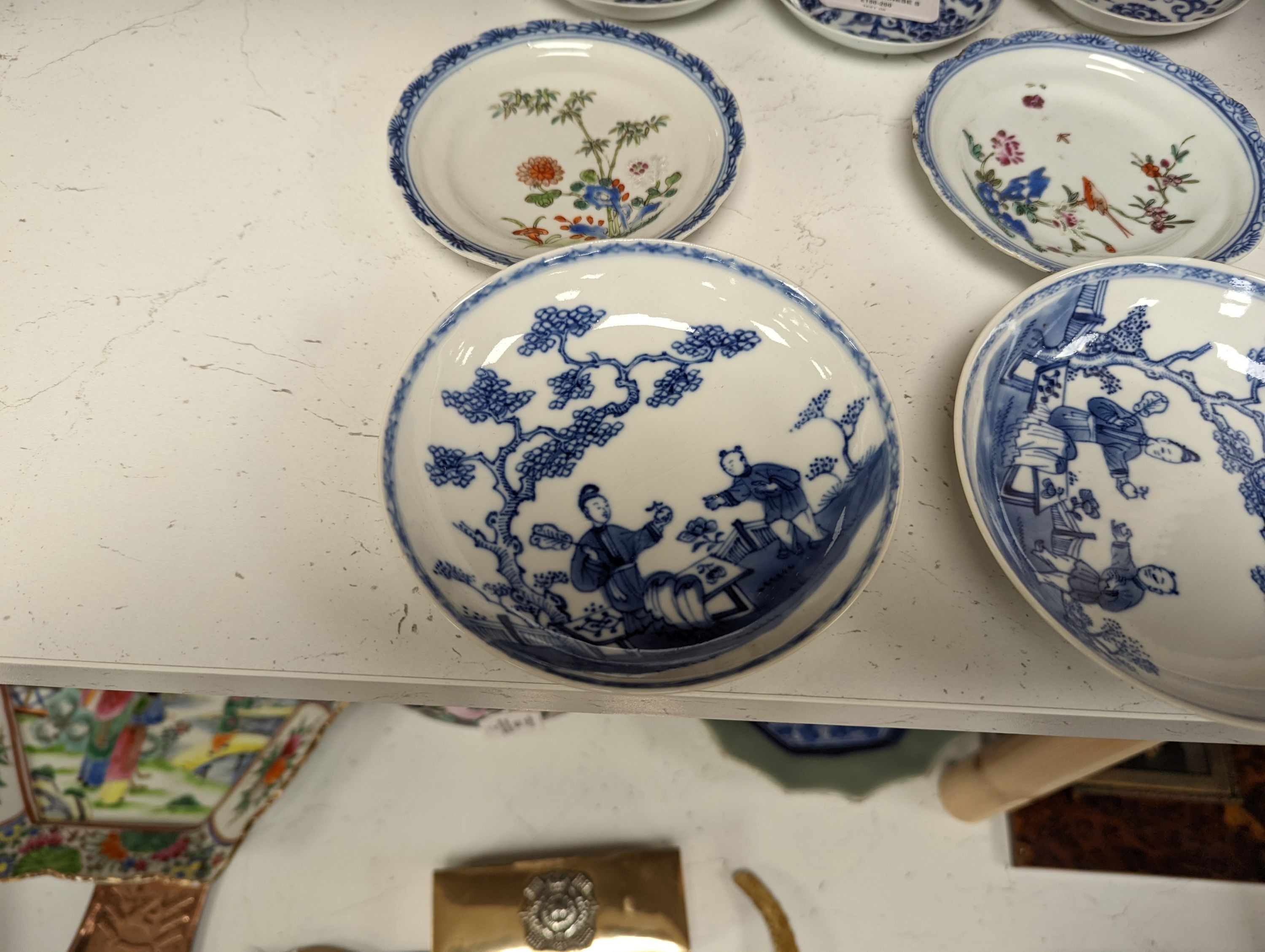 Seven 18th century Chinese saucer dishes, largest 14 cms diameter.
